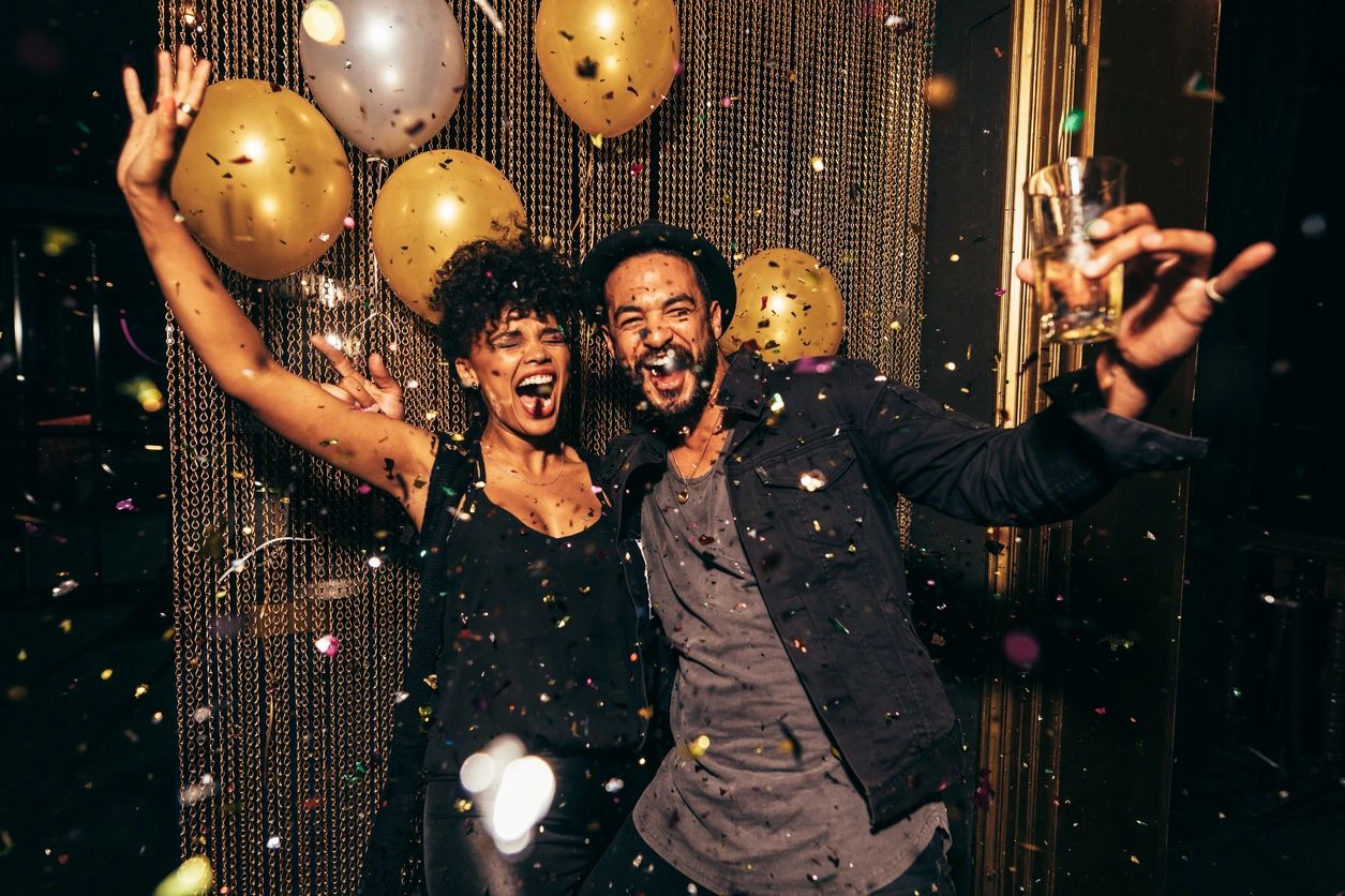Joyful corporate celebration with gold and silver balloons and confetti